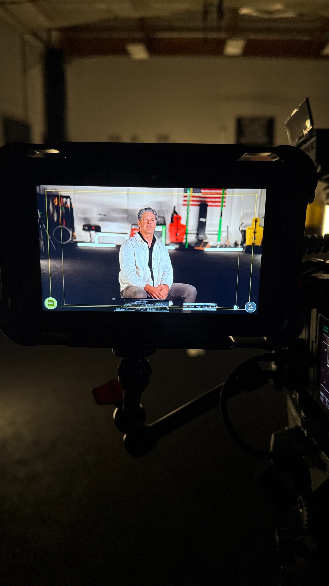 Supplied portrait photograph of a production monitor showing a seated interview subject.